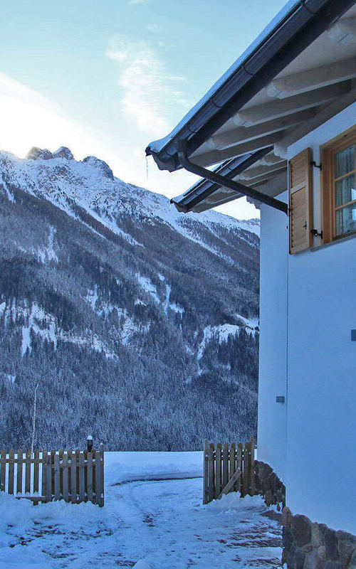 Chalet Nata Apartments House with garden & snow-covered mountain landscape