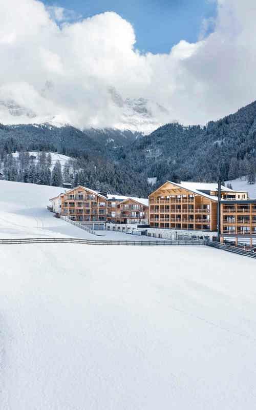 Cyprianerhof Wooden house in a snow-covered landscape in the mountains